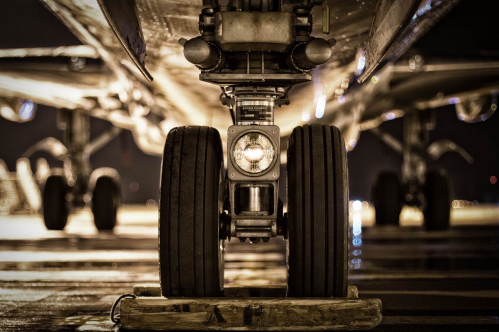 Black and white photo, close up of an airplane wheel.