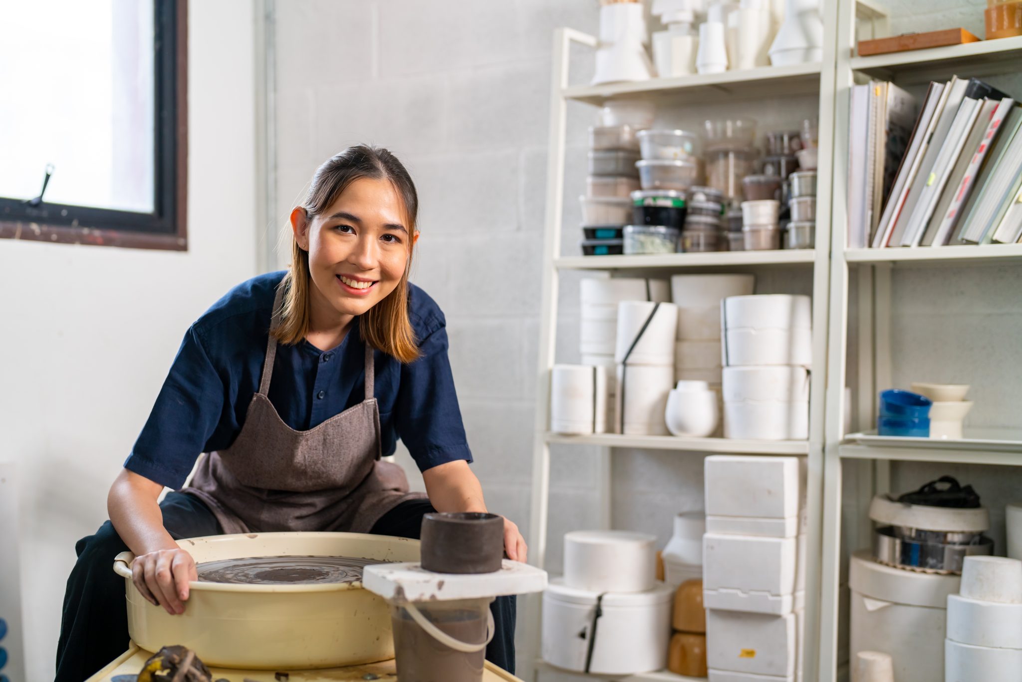 A lady sculptor showing her pottery.