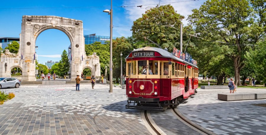 Bridge of Remembrance archway with red and yellow tram in foreground.