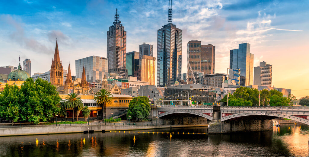 Melbourne skyline, Yarra River and footbridge in foreground.