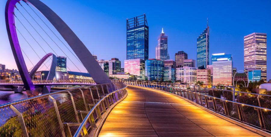 Perth skyline at dusk with curved Spanda sculpture at Perth riverfront in foreground.