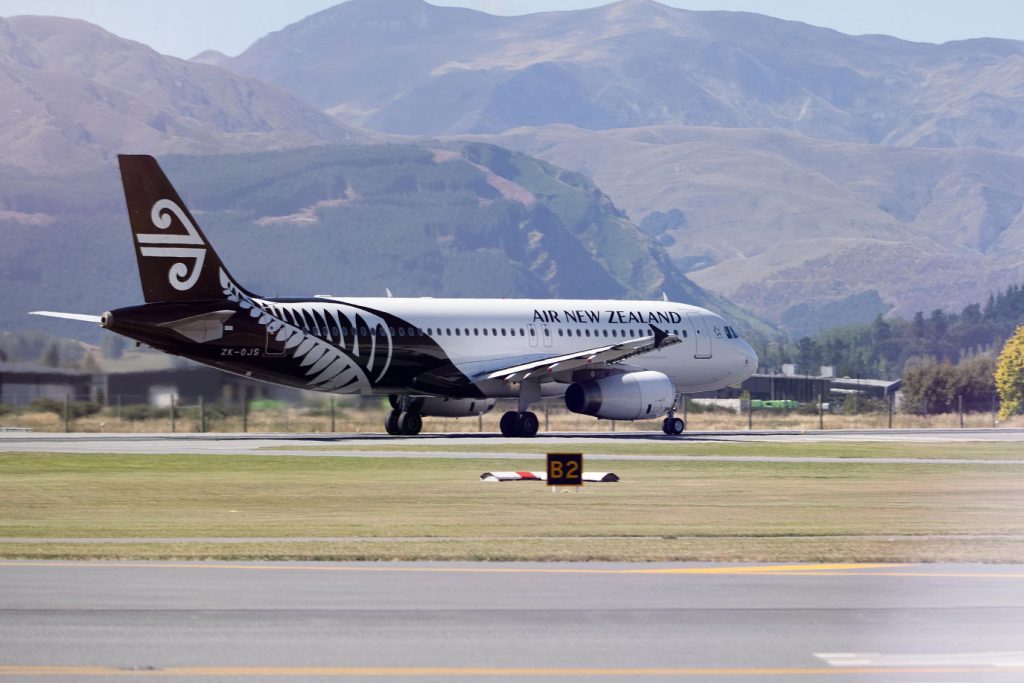 Air New Zealand plane taxiing along runway.