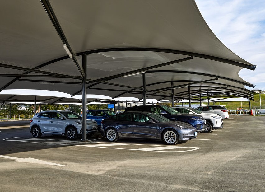 The Premium Car Park showing curved white roof with several cars below.