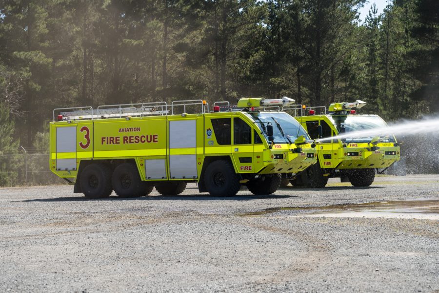 Aviation fire rescue vehicle on a natural landscape spraying water.