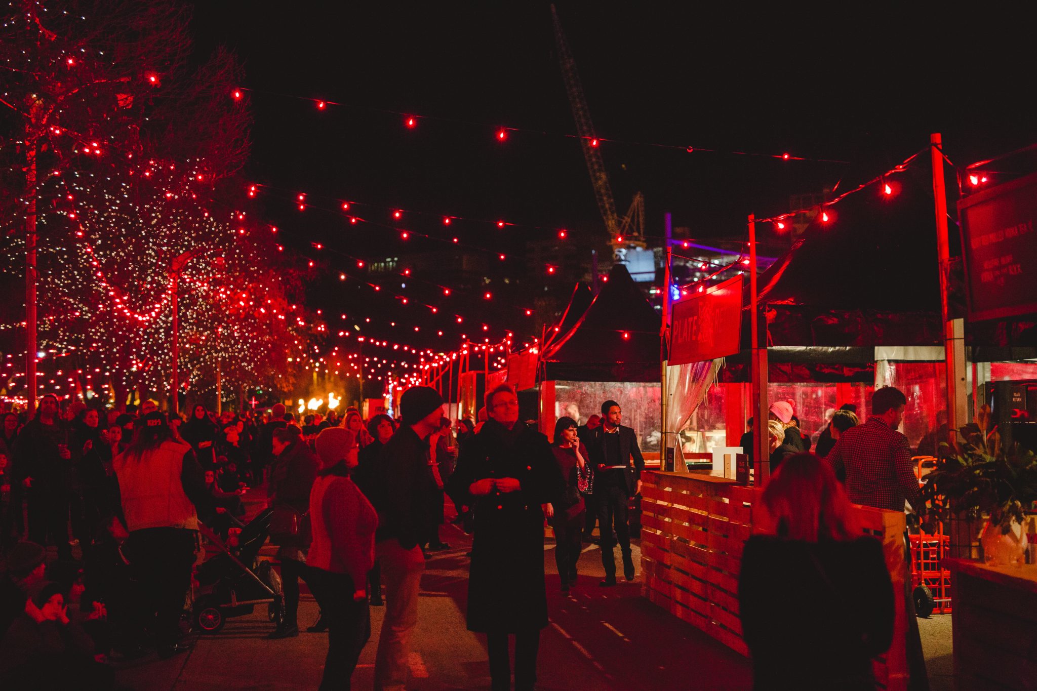Red lighting in dark streets at Dark Mofo event.